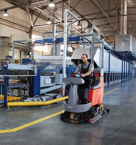 Objektpflege2 Mann auf einem Reinigungsfahrzeug in einer Werkhalle